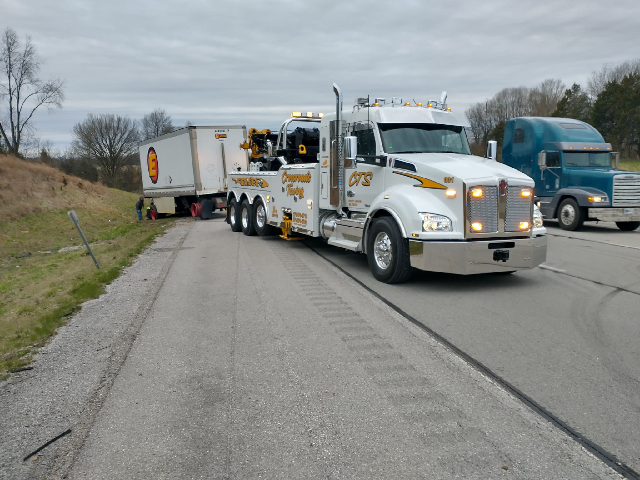 white tow truck hauling company load