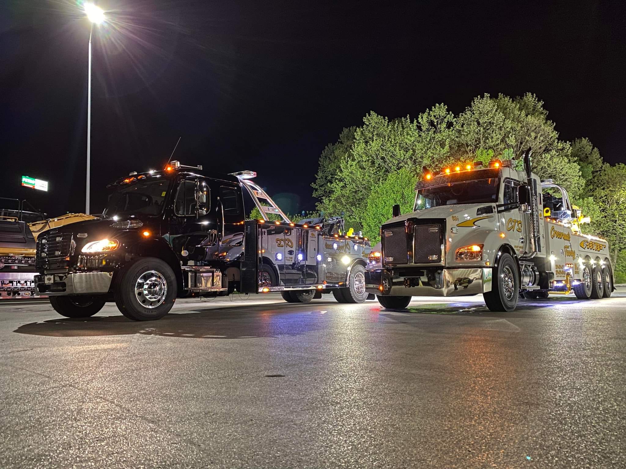 white and black heavy towing trucks at night