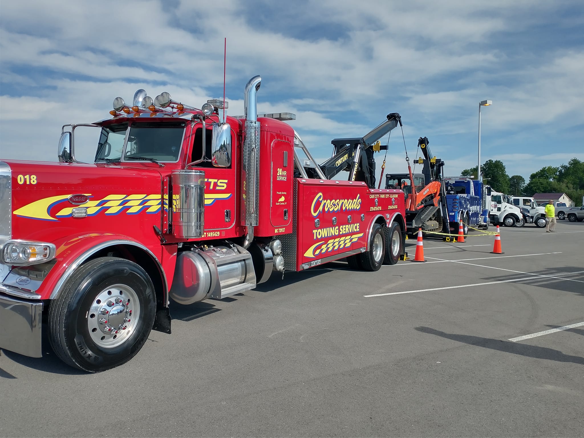 red crane truck lifting skidsteer
