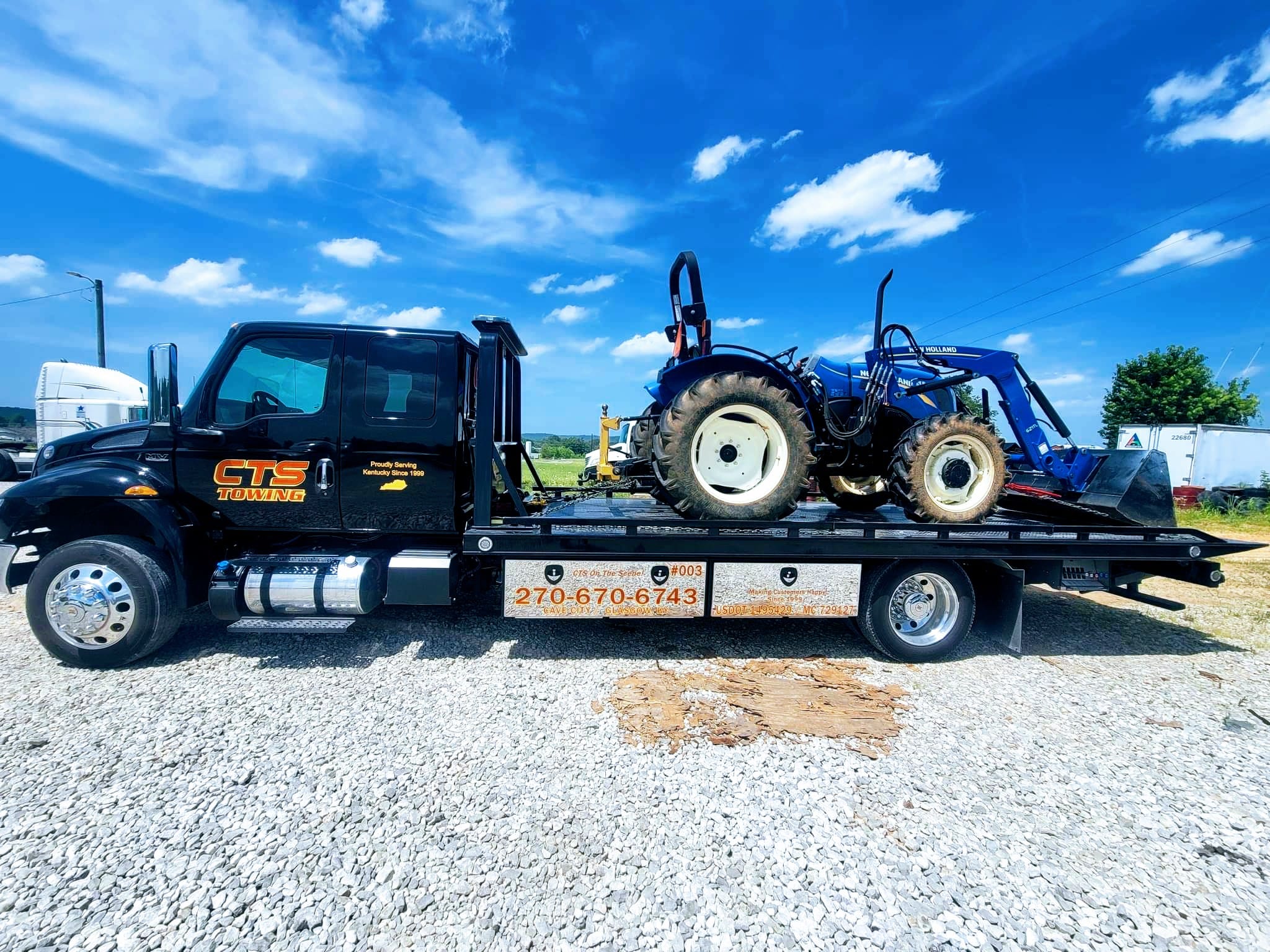 tow truck hauling tractor